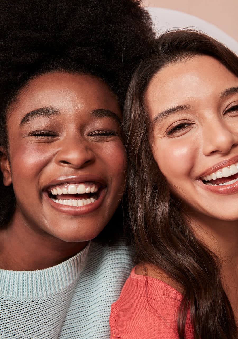 mulheres sorrindo com aparelho transparente